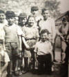 This photo  was taken in the yard of Redmans Rd Cheder circa 1938 and sent in by Ivan Metzger - the boy in the centre with his hands together.